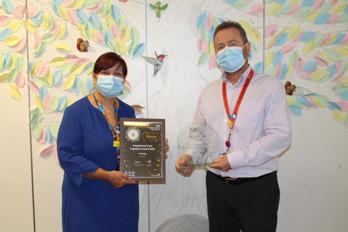 Cathy Winfield presenting David Simpson from Pathology team with trophy and certificate